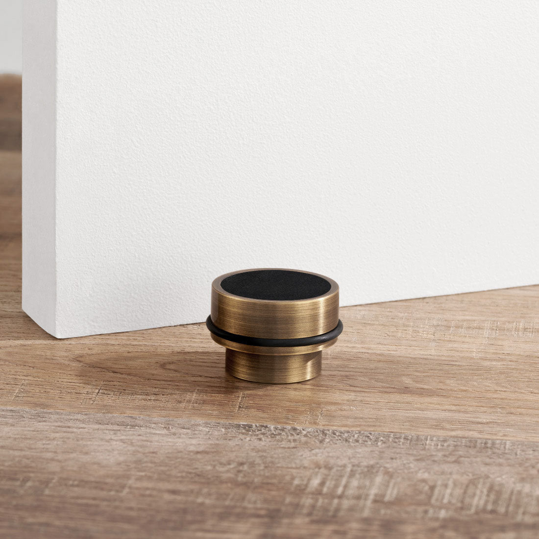 Brass & Black Leather Mounted Door Stops in Antique