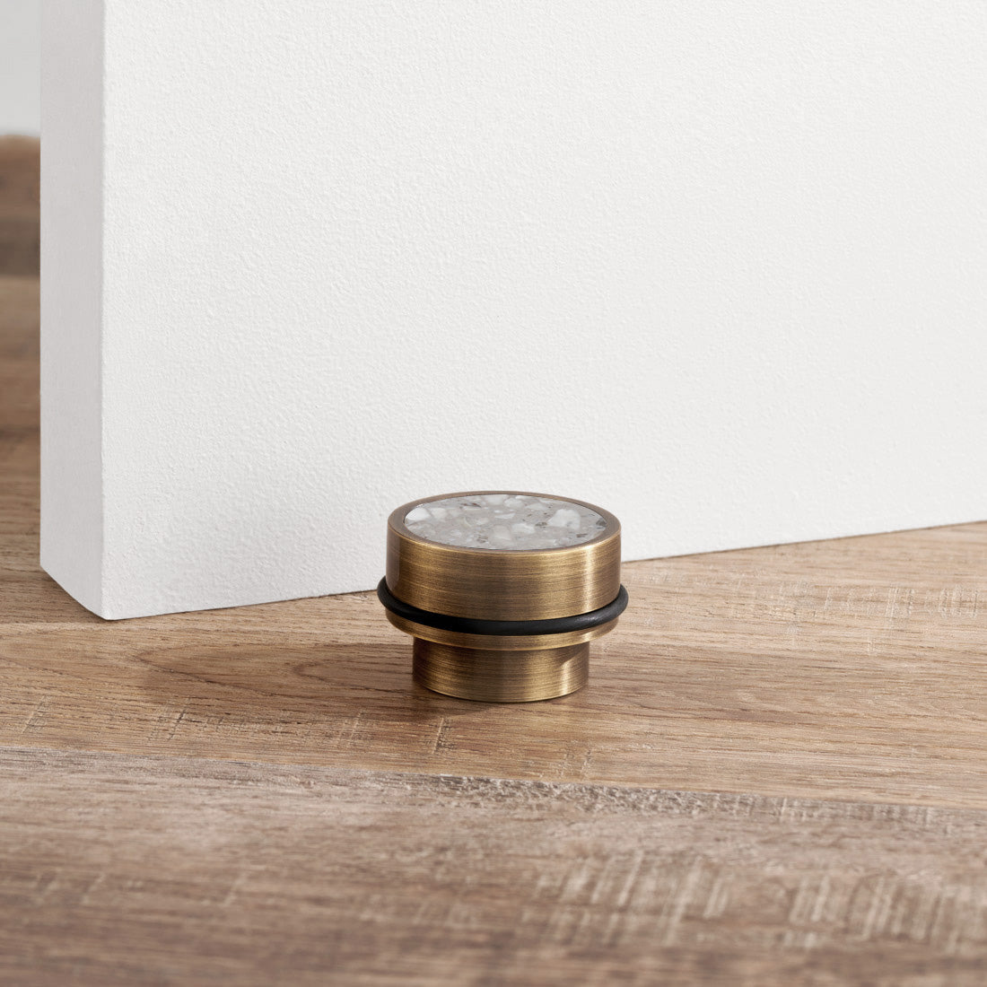 Brass & Grey Terrazzo Floor Mounted Door Stops in Antique