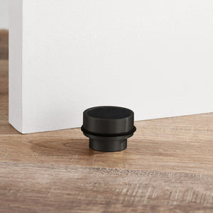 Brass & Black Leather Mounted Door Stops in Black