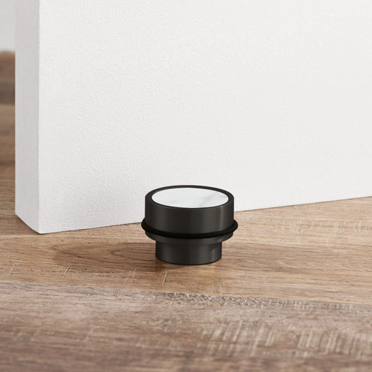 Brass & White Terrazzo Floor Mounted Door Stops in Black