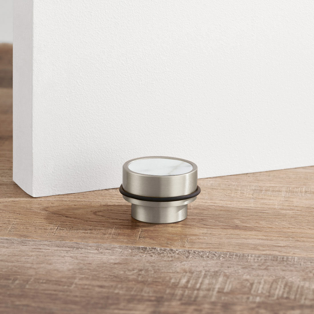 Brass & White Terrazzo Floor Mounted Door Stops in Silver