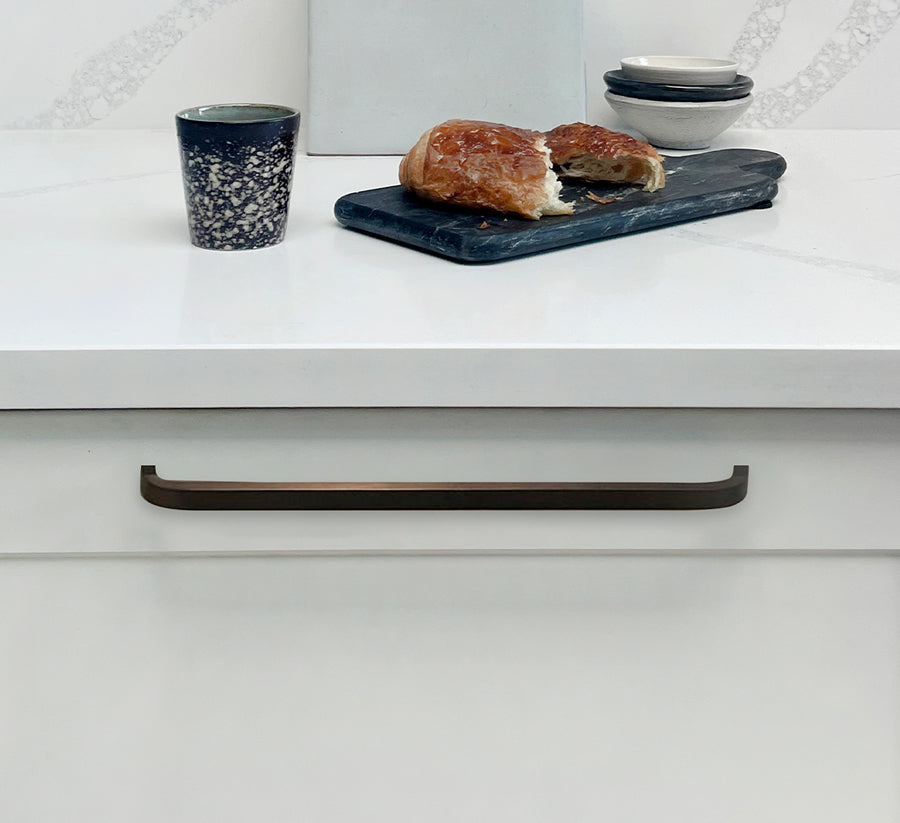 pushka white cupboard with pushka cabinet handle with a pastry, bowls and cutting board on top