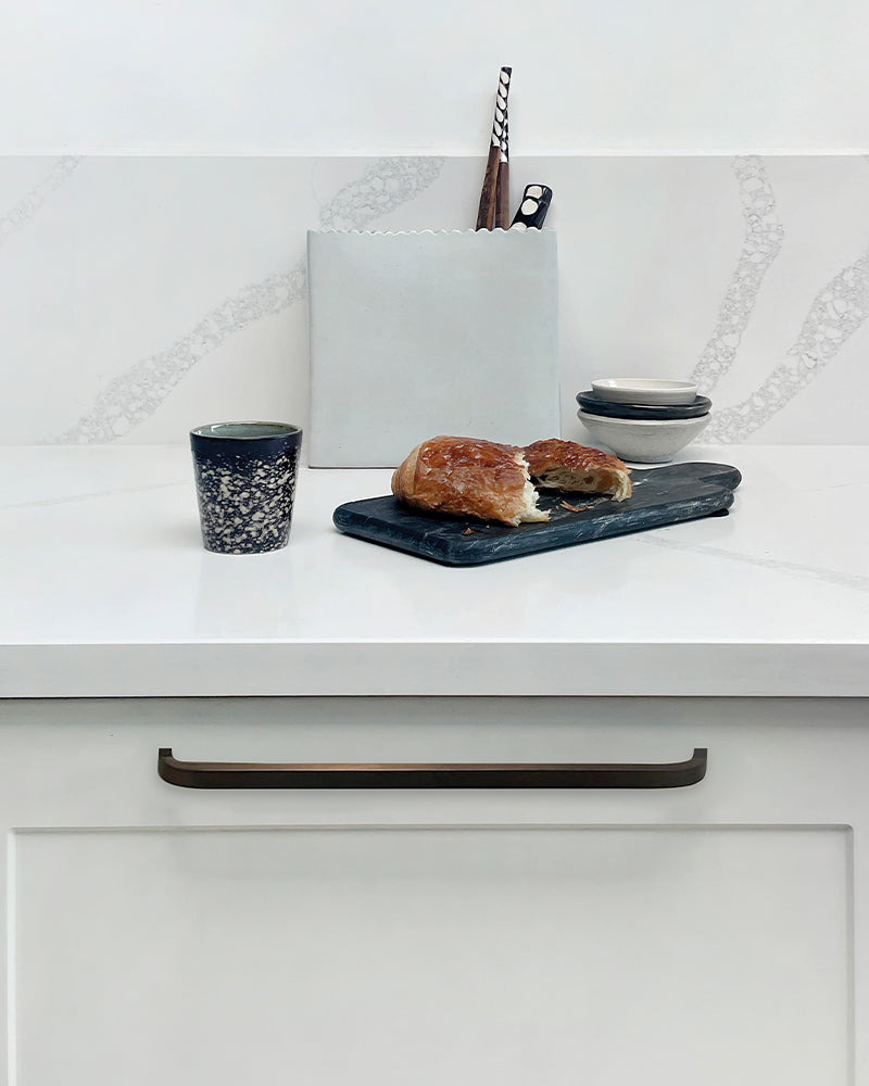 pushka white cupboard with pushka cabinet handle with a pastry, bowls and cutting board on top